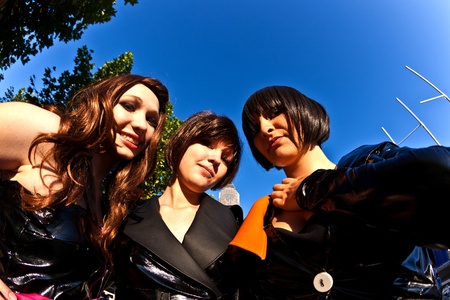 FRANKFURT, GERMANY - OCTOBER 10: Public day at Frankfurt international Book Fair, three girls in black in costumes  are posing for photografers on October 10, 2010 in Frankfurt, Germany.のeditorial素材
