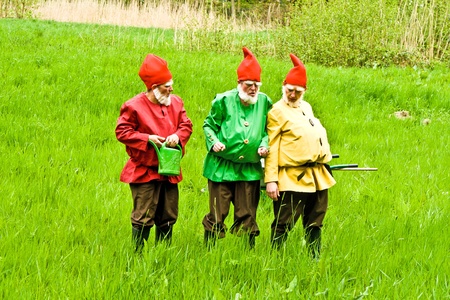 KRONBERG, GERMANY - MAY 01: three garden gnomes enjoy children at the festival for inauguration the New Quellenpark Kronberg on May 1, 2011 in Kronberg, Germany. The Quellenpark is a place with fresh natural mineral water and fertile marsh.のeditorial素材