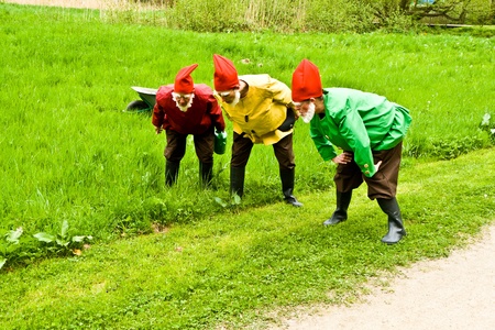 KRONBERG, GERMANY - MAY 01: three garden gnomes enjoy children at the festival for inauguration the New Quellenpark Kronberg on May 1, 2011 in Kronberg, Germany. The Quellenpark is a place with fresh natural mineral water and fertile marsh.のeditorial素材
