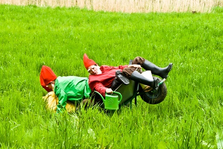 KRONBERG, GERMANY - MAY 01: three garden gnomes enjoy children at the festival for inauguration the New Quellenpark Kronberg on May 1, 2011 in Kronberg, Germany. The Quellenpark is a place with fresh natural mineral water and fertile marsh.のeditorial素材