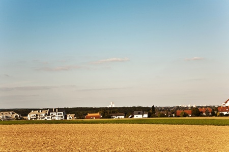 new built housing area in beautiful landscape with view over golden acres and fields and in beautiful natureの写真素材