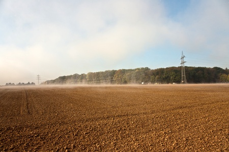 a pylon will be setted up in foggy weather in beautiful landscape with acres in fog