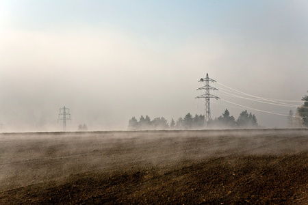 a pylon will be setted up in foggy weather in beautiful landscape with acres in fog