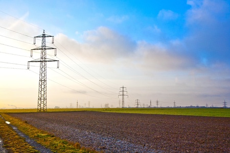 electrical tower in landscape with dark cloudsの写真素材