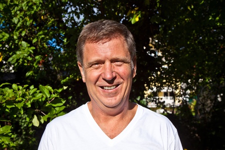portrait of happy attractive man in the garden