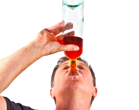 man drinking alcohol out of the bottleの写真素材