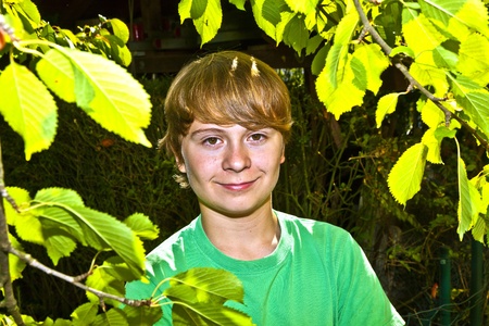 cute smart boy in the garden under the  treeの写真素材