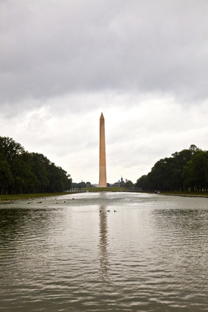 Outdoor view of Washington Monument in Washington DC in dark cloudsの写真素材