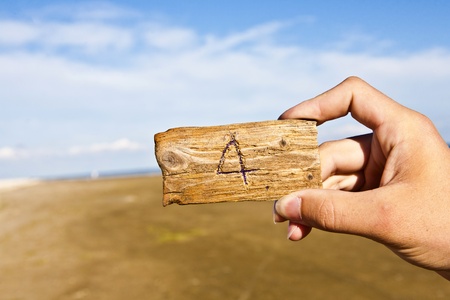 peace of wood with an engraved number with blue skyの写真素材