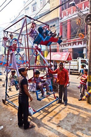 DELHI, INDIA - NOV 9: children have fun in a wheel at Chawri Bazar on November 08,2011 in Delhi, India. Established in 1840, with a hardware market, it was the first wholesale market of Old Delhi.のeditorial素材