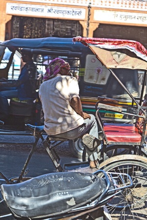 JAIPUR, INDIA - NOVEMBER 12: man rests in his Cycle rickshaw on November 12, 2011 in Jaipur, India. Cycle rickshaws were introduced in the 1940's and have a fixed quota of licenses.のeditorial素材