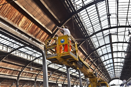 WIESBADEN, GERMANY - October 3: workers repaire the more than 100 years old roof of classicistical train station on October 3,2011 in Wiesbaden, Germany.のeditorial素材