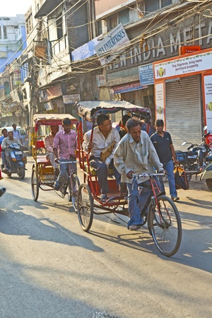 DELHI, INDIA - NOV 8: Rickshaw rider transports passenger early morning on November 08,2011 in Delhi, India. Cycle rickshaws were introduced in Delhi in the 1940's and have a fixed quota of licenses.のeditorial素材