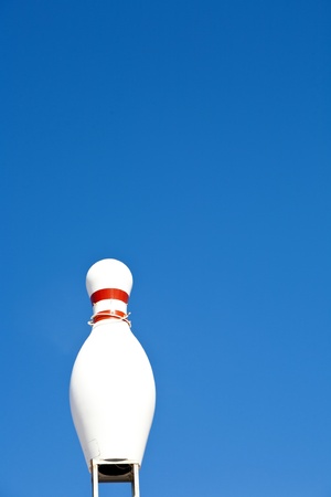 bowling pin in blue sky as symbol for a bowling placeの写真素材