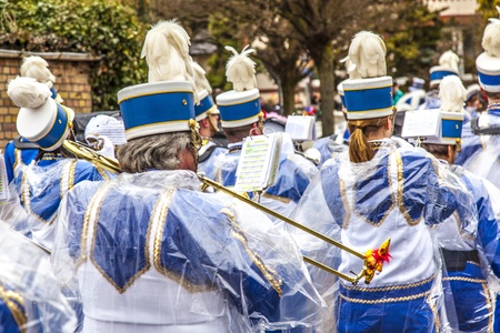 SCHWALBACH, GERMANY - FEBRUARY 27: The carnival  brass band moves through the city in rain on February 27, 2011 in Schwalbach, Germany. The Brass Band Rheinmain Taunus takes part as hosts.のeditorial素材