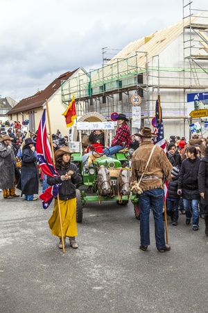 SCHWALBACH, GERMANY - FEBRUARY 27: The people watch the carnival parade on February 27, 2011 in Schwalbach, Germany. The parade is the annual event in the city and people like to collect sweets.のeditorial素材
