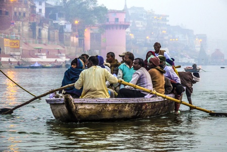 VARANASI - INDIA, JANUARY 1: Hindu people in a boat on river Ganga in the holy city of Varanasi. The holy ritual of washing is held every day in Varanasi, India, January 1,2012 .のeditorial素材