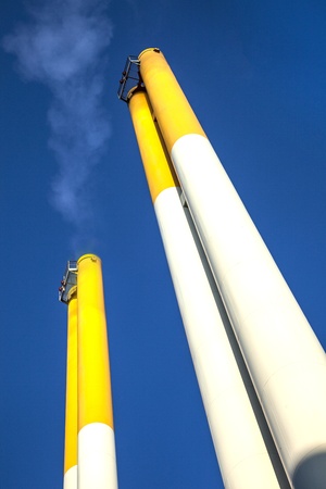 chimney with smoke and blue skyの写真素材