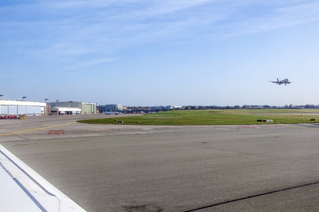 HAMBURG, GERMANY - MARCH 26: Aircraft heading to take off with view to the Lufthansa Technik Wharft on March 26,2011 in Hamburg, Germany. The wharft covers more than 30.000 SQM to overhaul complete aircrafts.のeditorial素材
