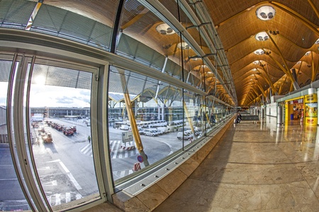 MADRID - APRIL 1: Passengers walk by at the new terminal T4 at Barajas airport on April 1,2012 in Madrid. This addition opened 2006 makes Madrid the 2. largest airport in the world.のeditorial素材