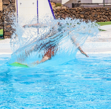 boy has fun jumping in the pool