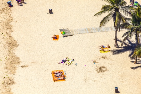 ARRECIFE, SPAIN - APRIL 8: beach with tourists in summer on April 8,2012 in Arrecife, Spain. The...