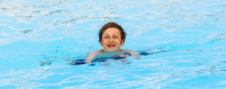 cute boy swimming in the poolの写真素材