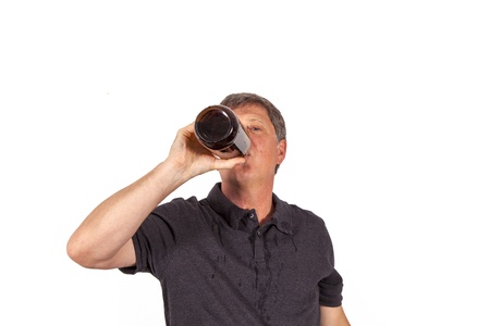 man drinking out of a bottle