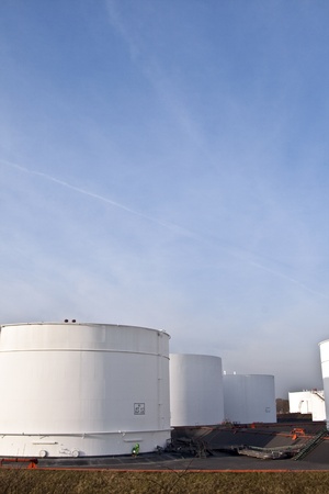 white tanks in tank farm with blue skyのeditorial素材