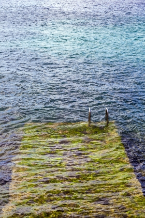 Old ladder to the sea from a tourist ressortの写真素材