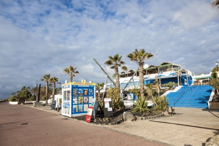 PLAYA BLANCA, SPAIN- APRIL 4: shops and restaurants of shopping center Punta Limones on the seafront promenade, Lanzarote is a preferred winter destination for Europeans, on April 4, 2012 in Playa Blanca, Spain.のeditorial素材