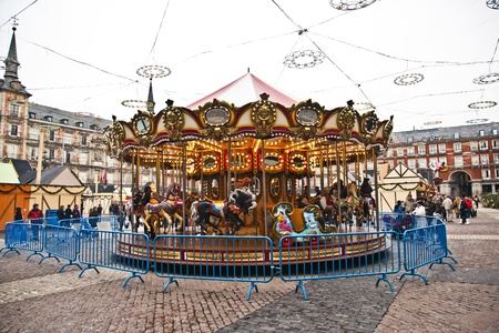 MADRID, SPAIN DEZEMBER 12: carousel for children at Madrids Plaza de major in Christmas time on December 12,2010 in Madrid, Spain. The square was inaugurated in 1620 by Felipe III.のeditorial素材