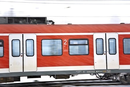 train in Wintertime on track in heavy snow flurry