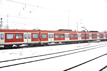 train in Wintertime on track in heavy snow flurry
