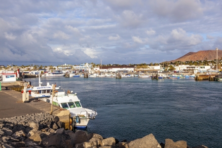 PLAYA BLANCA, SPAIN- APRIL 4: boats lying in the harbor on April 4, 2012 in Playa Blanca, Spain. Canary Islands are a favorite winter destination for Europeans.のeditorial素材