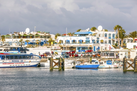 PLAYA BLANCA, SPAIN- APRIL 4: boats lying in the harbor on April 4, 2012 in Playa Blanca, Spain. Canary Islands are a favorite winter destination for Europeans.のeditorial素材