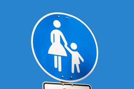 Child pedestrian roadsign over blue skyの写真素材
