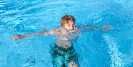 cute boy swimming in the poolの写真素材