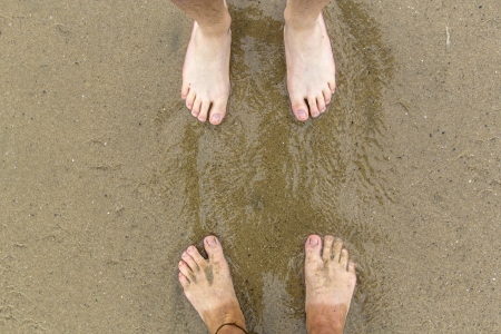 feet of father and son at the beachの写真素材