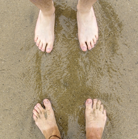 feet of father and son at the beachの写真素材