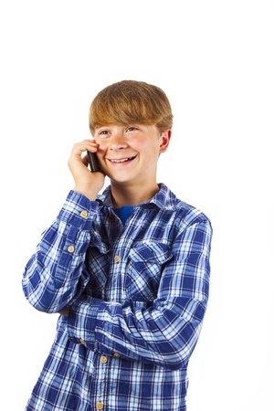 cute handsome young boy speaking a mobile phoneの写真素材