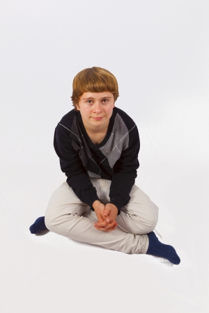 smart happy young boy posing in studioの写真素材