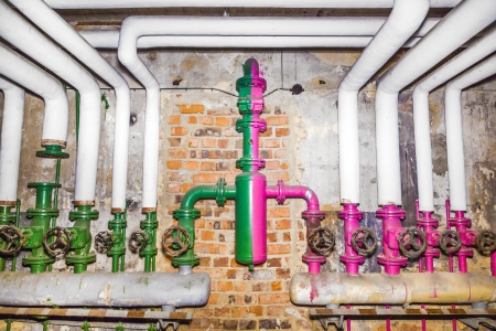 old pipelines with valve for a rotten water heating and controling plantの写真素材