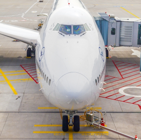 FRANKFURT, GERMANY - October 13: Lufthansa B747 800 airplane parked on Frankfurt airport while people are boarding to the flight to Delhi on October 13,2012 in Munich, Germany.のeditorial素材