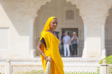 AMER, INDIA - 19 NOVEMBER: woman of fourt class in brightly colored sari clean the Amber palace on November 19,2012 in Amer,India. They earn 300 IRP for two hours paid by the government.のeditorial素材