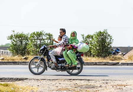RAJASTHAN - INDIA - OCTOBER 17: Mother, father baby and small child ride scooter at the highway on...