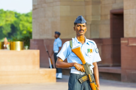 NEW DELHI - INDIA, OCT 16: soldier in parade uniform guards the indian gate with a gun in his hand...