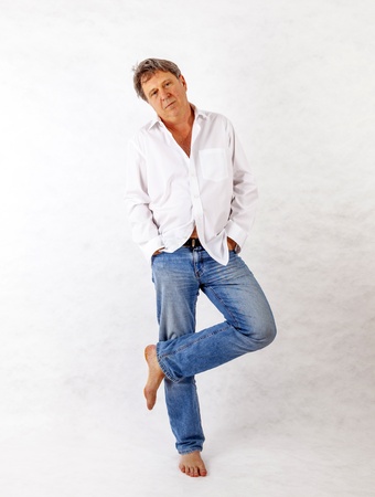 Mature man standing up against a white backgroundの写真素材