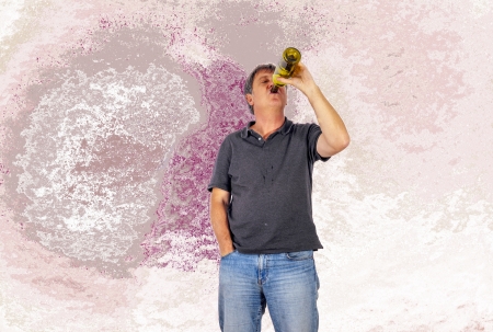 mature man drinks alcohol out of a bottle