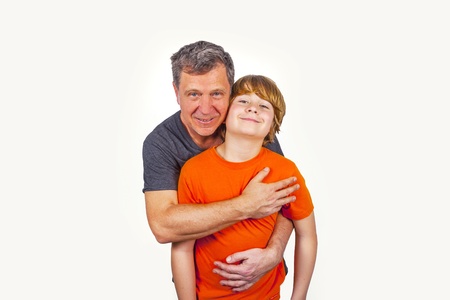 father and son hugging in studio isolated on whiteの写真素材